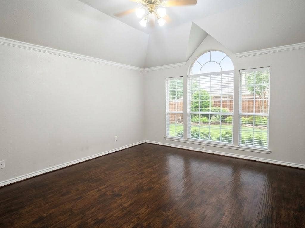 2609 Townshed Drive, Garland, TX 75044 Vaulted ceiling with crown molding, wood-finish flooring, and arched window