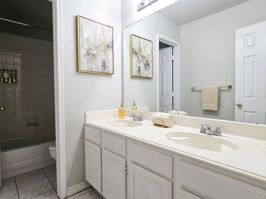 2609 Townshed Drive, Garland, TX 75044 Dual vanity with integrated sinks, chrome faucets, and white cabinetry