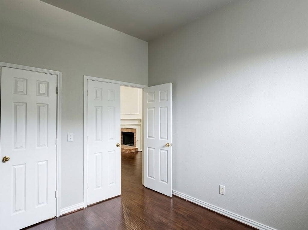 2609 Townshed Drive, Garland, TX 75044 Wood-finish flooring throughout, white paneled doors, and light-toned walls