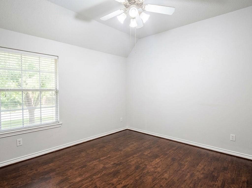 2609 Townshed Drive, Garland, TX 75044 Vaulted ceiling with a ceiling fan, wood-finish flooring, and a large window with blinds