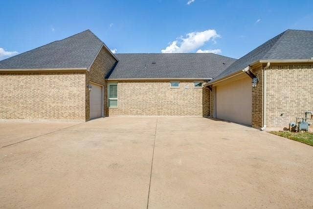 1314 Prestwick Court, Granbury, TX 76048 Side entrance garages. Two car and separate golf cart garage