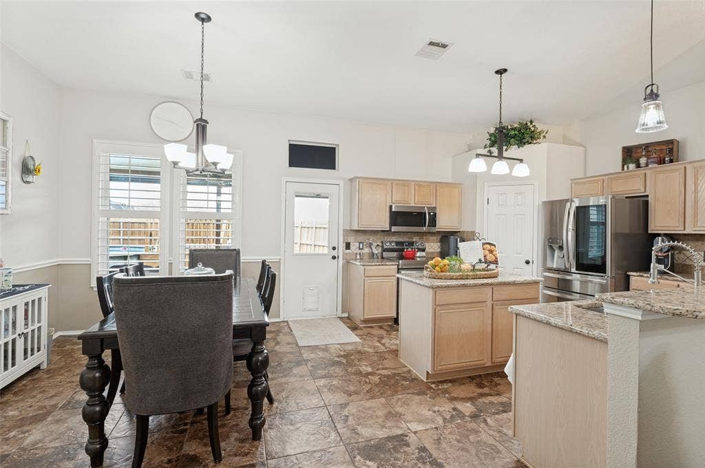 Kitchen featuring a central island, recessed lighting, and stainless steel appliances