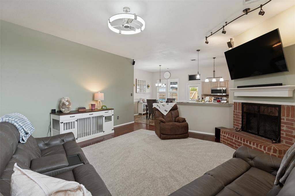 Fireplace with red brick surround and white mantel