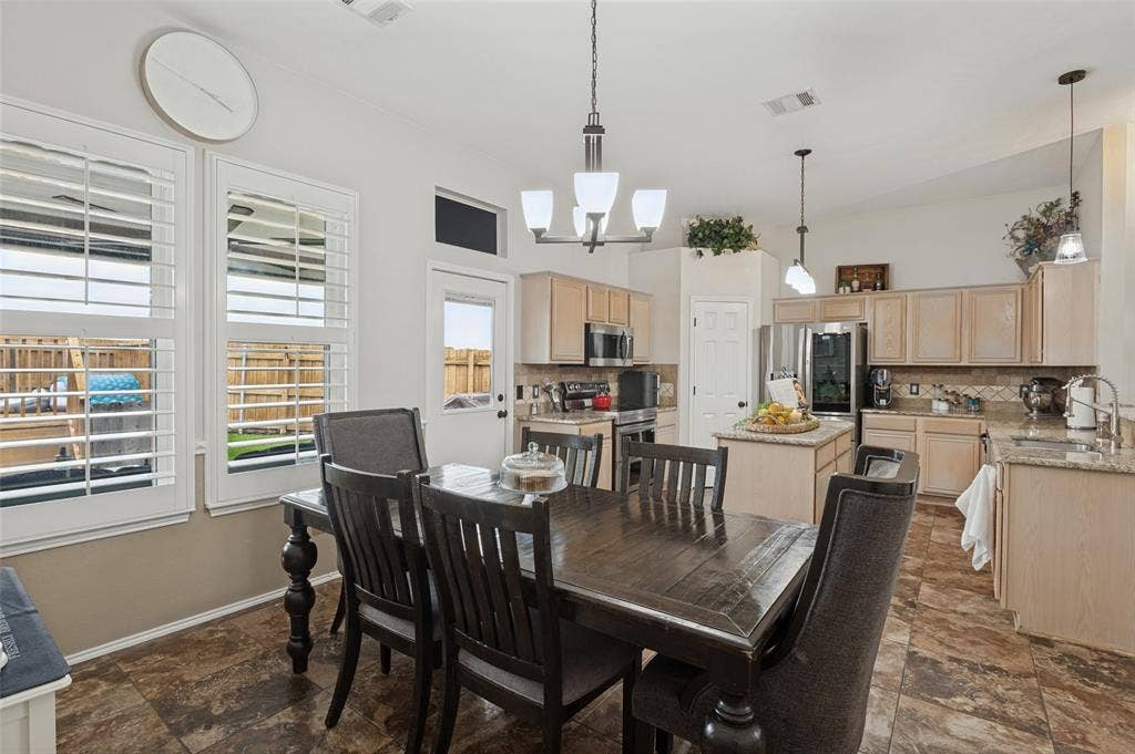Kitchen featuring light wood-finish cabinetry, granite countertops, and stainless steel appliances