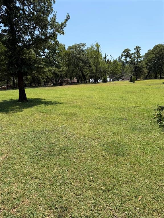 2300 Spring Mountain Road, Cross Roads, TX 76227 Expansive green lawn with mature trees and a clear sky