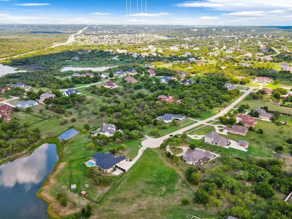 1036 Lighthouse Court, Grand Prairie, TX 75104 Expansive residential area featuring numerous properties, surrounding natural landscape, visible bodies of water, and a prominent road system
