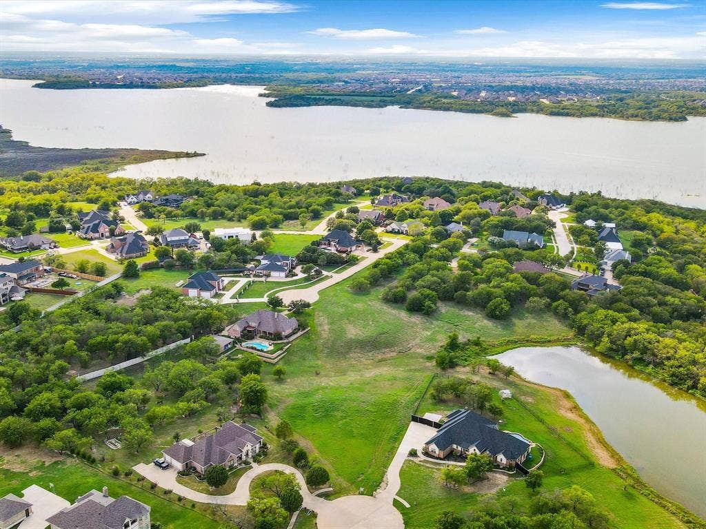 1036 Lighthouse Court, Grand Prairie, TX 75104 Residential development featuring a large body of water, extensive green spaces, and mature trees
