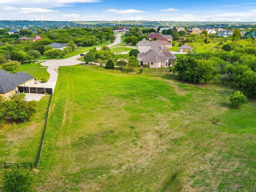 1036 Lighthouse Court, Grand Prairie, TX 75104 Expansive green lot featuring mature trees and a gently sloped terrain