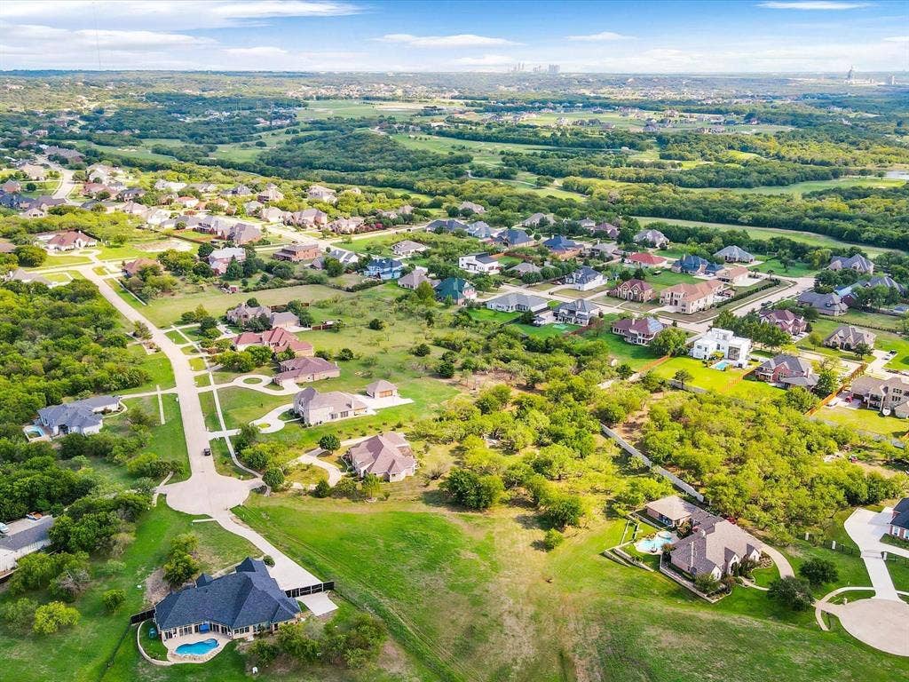 1036 Lighthouse Court, Grand Prairie, TX 75104 Residential community featuring tree-lined streets, varied architectural styles, and private swimming pools