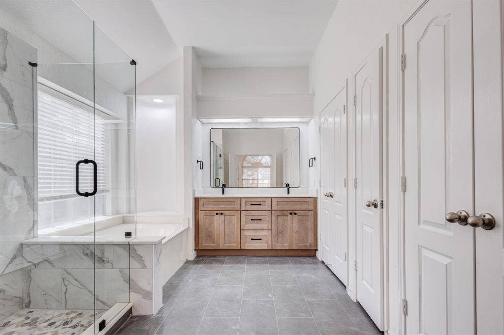 1306 Bentley Drive, Carrollton, TX 75006 Bathroom featuring tile patterned flooring, dual bowl vanity, and separate shower and tub