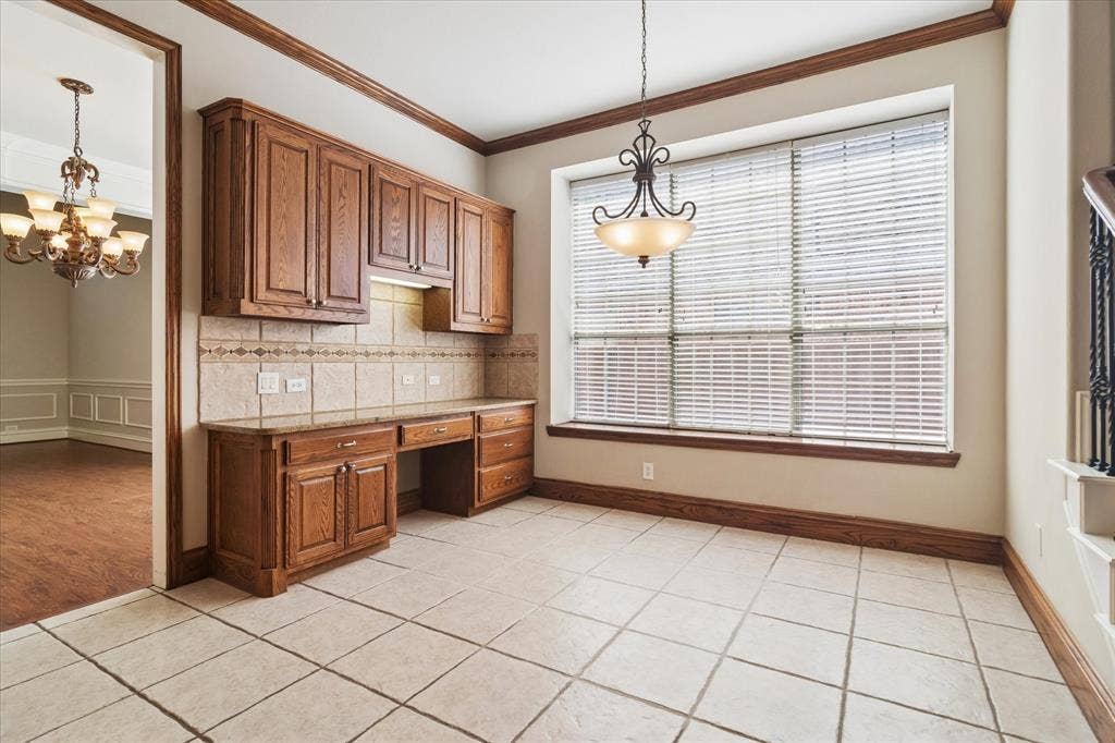 8323 Albritton Drive, Frisco, TX 75036 Built-in wood cabinetry with integrated desk space, ceramic tile flooring, large window with blinds, and decorative light fixture