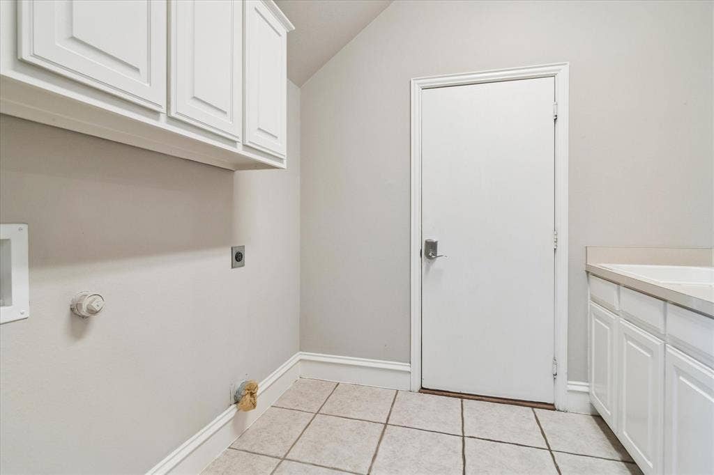 8323 Albritton Drive, Frisco, TX 75036 Tile flooring, built-in upper cabinetry, built-in lower cabinetry, solid surface countertop, utility connections