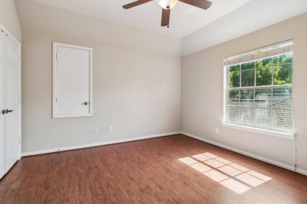 8323 Albritton Drive, Frisco, TX 75036 Room featuring wood-finish flooring, a ceiling fan, and a paneled door