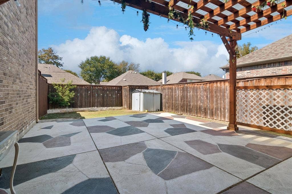 8323 Albritton Drive, Frisco, TX 75036 Custom-patterned concrete patio with a wooden pergola
