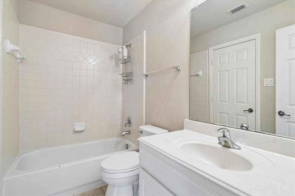 8323 Albritton Drive, Frisco, TX 75036 White vanity with an integrated sink and chrome faucet