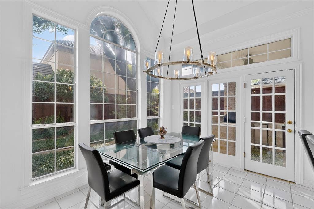 4536 Briar Oaks Circle, Dallas, TX 75287 Vaulted ceiling with an ornate chandelier, arched window, French doors, and tile flooring