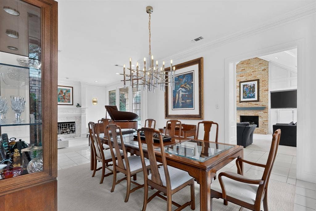 4536 Briar Oaks Circle, Dallas, TX 75287 White wall finishes, crown molding, and a contemporary chandelier illuminate this space