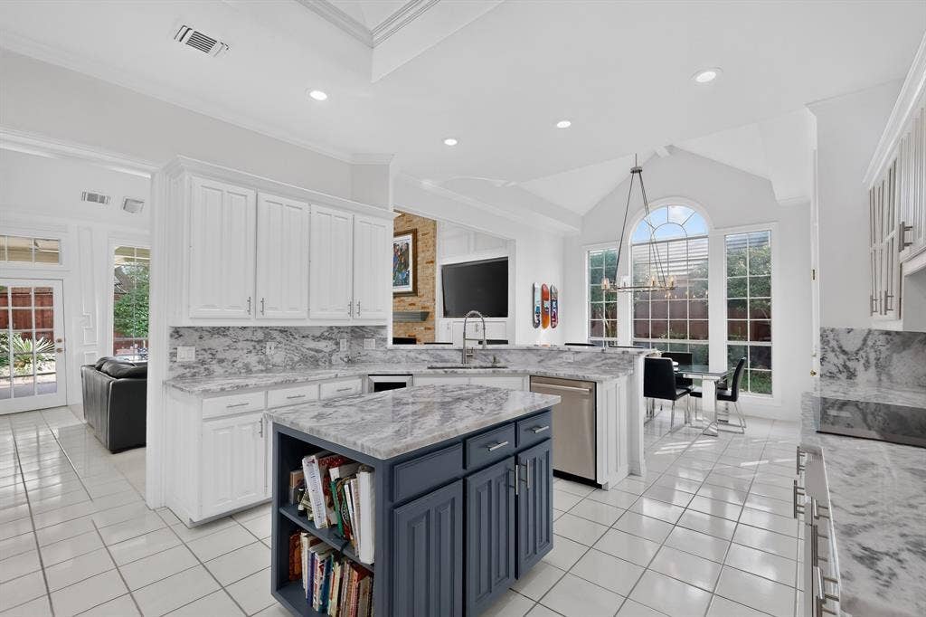4536 Briar Oaks Circle, Dallas, TX 75287 White cabinetry featuring stone countertops and backsplash