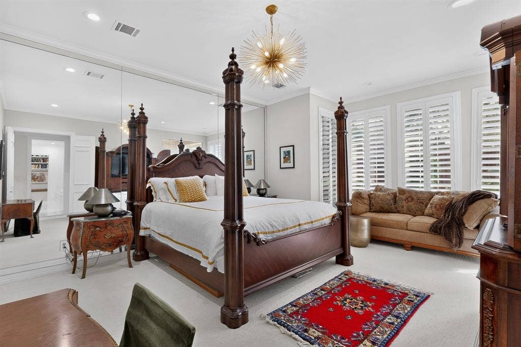4536 Briar Oaks Circle, Dallas, TX 75287 Wall-to-wall carpeting, crown molding, plantation shutters, and a modern sputnik chandelier