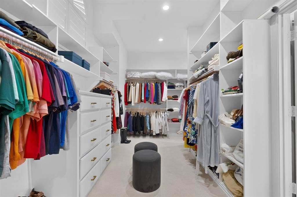 4536 Briar Oaks Circle, Dallas, TX 75287 Custom built-in storage, extensive shelving, integrated hanging rods, recessed lighting, and wall-to-wall carpeting