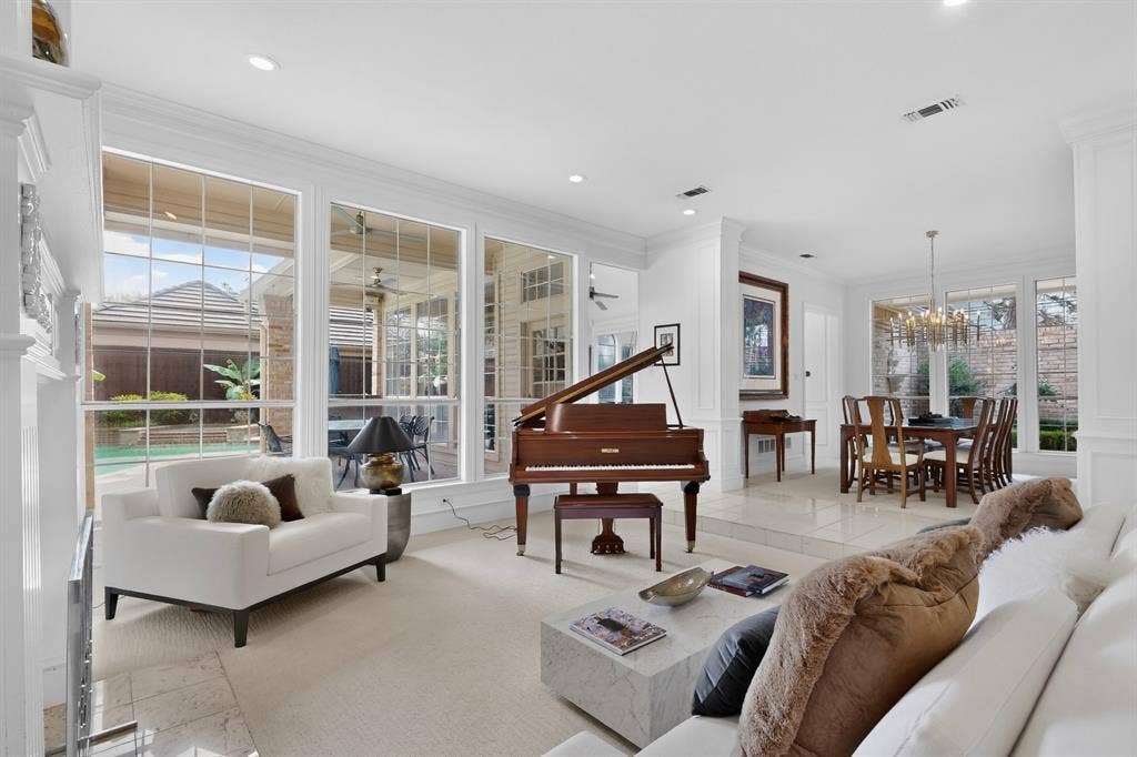4536 Briar Oaks Circle, Dallas, TX 75287 Expansive windows with transom details, recessed lighting, crown molding, and a dining area with a chandelier