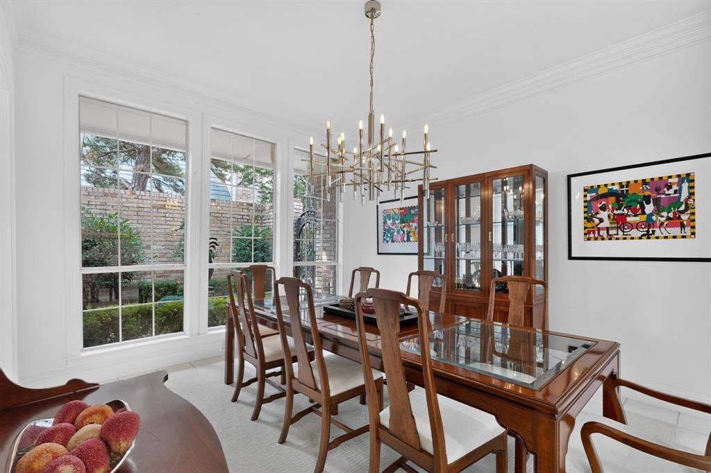 4536 Briar Oaks Circle, Dallas, TX 75287 Multiple large windows with white trim, contemporary chandelier, crown molding, and light-toned flooring