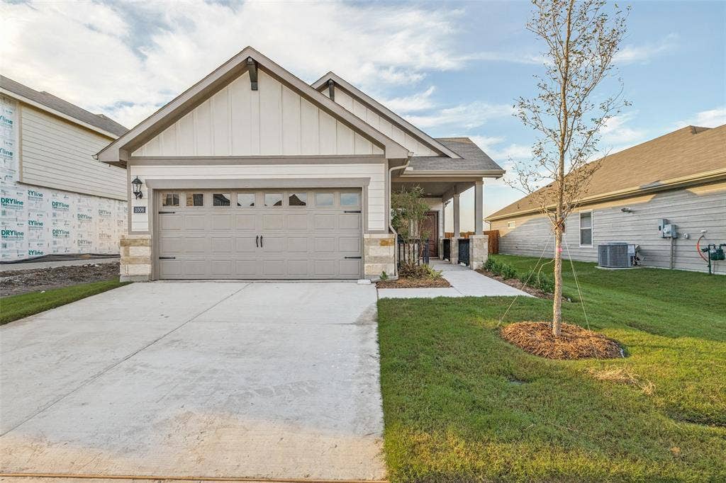 1006 Angel Street, Josephine, TX 75173 Fresh Curb Appeal & Everyday Convenience - Classic bungalow-inspired architecture, contrasting exterior trim, an attached two-car garage with Wi-Fi-enabled opener, and a spacious driveway create an inviting first impression with practical features for everyday living.