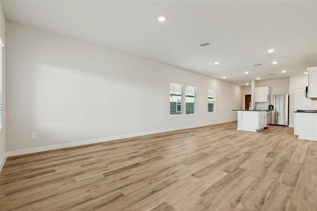 1006 Angel Street, Josephine, TX 75173 Room to Gather, Relax & Entertain! - This expansive view highlights the home's thoughtfully designed living spaces, with generous room for comfortable seating, dining, and entertaining. The kitchen's central island keeps everything connected while maintaining distinct areas for daily activities.