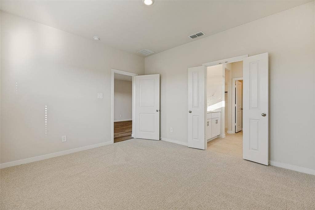 1006 Angel Street, Josephine, TX 75173 Privacy & Convenience in the Primary Suite! - A thoughtfully designed bedroom layout offers plenty of space to unwind, with direct access to the private ensuite bathroom featuring a double-sink vanity, separate shower, and walk-in closet.