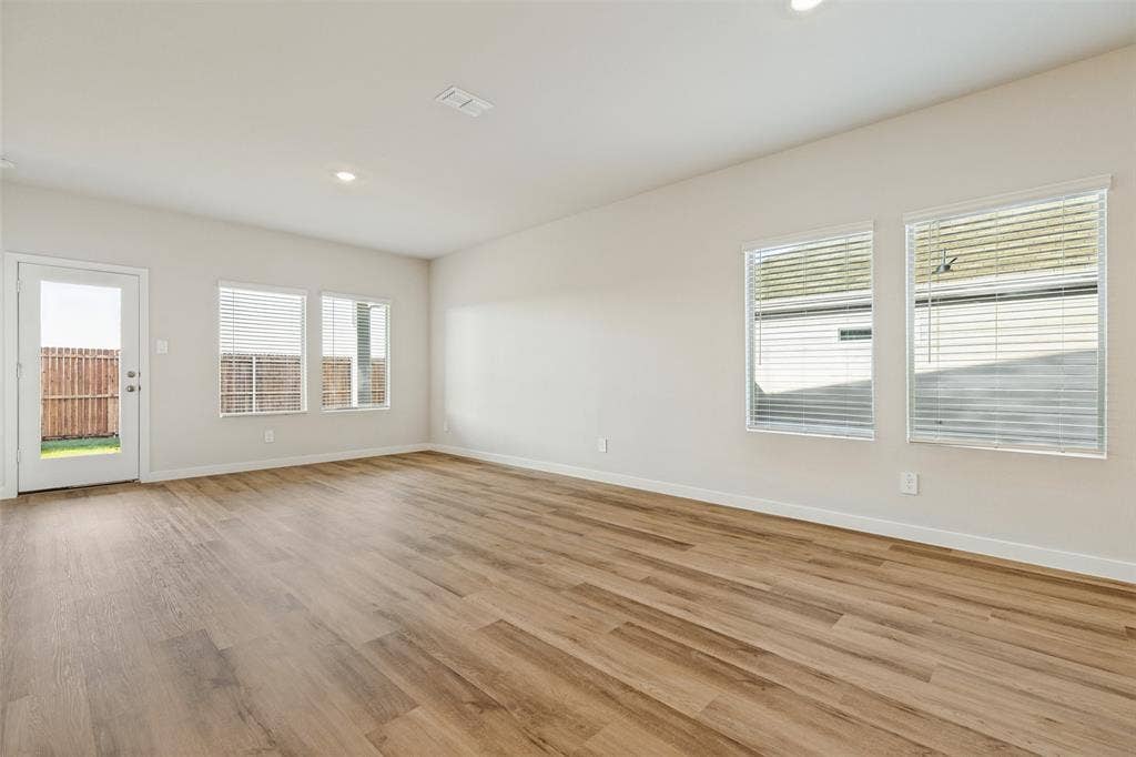 1006 Angel Street, Josephine, TX 75173 Natural Light Makes All the Difference! - Multiple windows brighten the open living and dining spaces, while included window blinds provide added convenience. Easy access to the covered back patio extends your living experience outdoors.