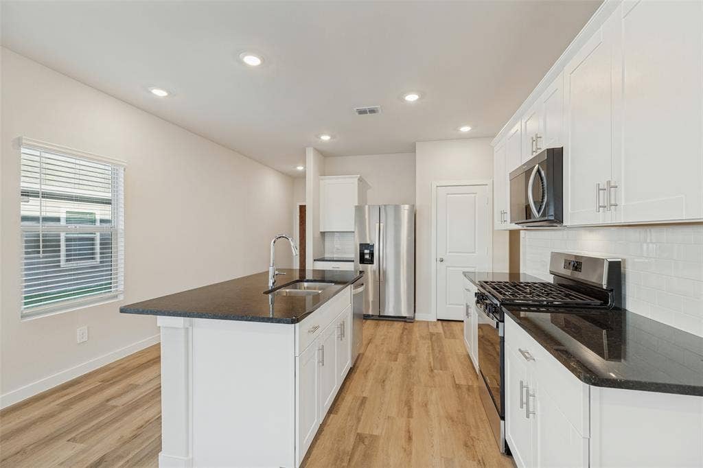 1006 Angel Street, Josephine, TX 75173 Made for Cooking & Conversation! - The stainless steel gas range, built-in microwave, and easy-care tile backsplash create a practical cooking area, while the generous granite countertops and nearby island make meal preparation and gathering effortless.