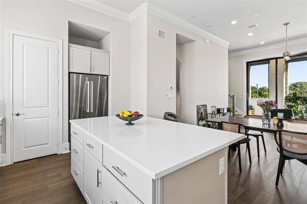 The oversized island provides generous storage, with ceiling prewiring in place for future pendant lighting.