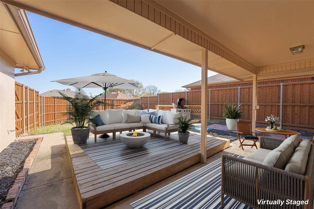 410 W Oak Street, Wylie, TX 75098 Expansive backyard featuring a covered patio, wood deck, and perimeter fencing