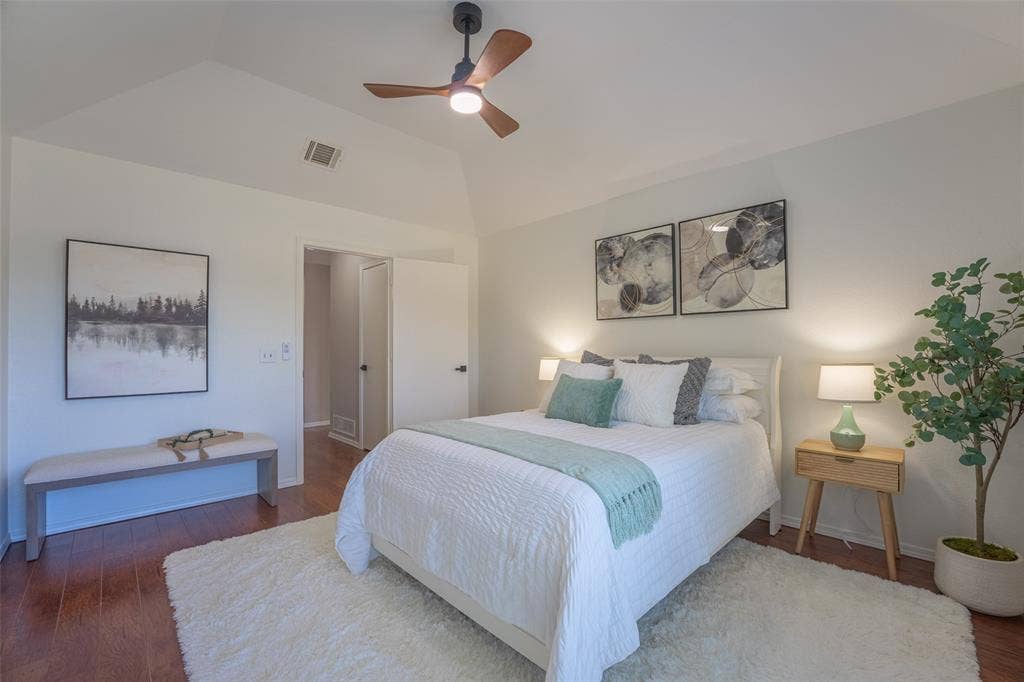 410 W Oak Street, Wylie, TX 75098 Vaulted ceiling with an integrated ceiling fan, wood-finish flooring, and crisp white walls