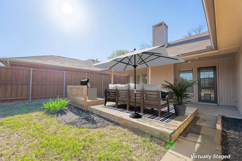 410 W Oak Street, Wylie, TX 75098 Wooden deck with lattice accent, surrounded by a wood-paneled fence