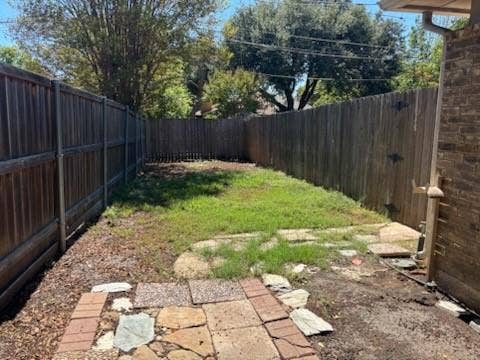 3028 Airhaven Street, Dallas, TX 75229 Fenced backyard featuring a wooden privacy fence, and a stone and brick paver pathway