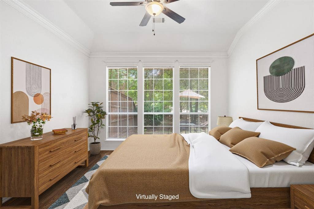 4816 Rockcreek Lane, Plano, TX 75024 Vaulted ceilings with crown molding, ceiling fan, wood-finish flooring, and large multi-pane windows