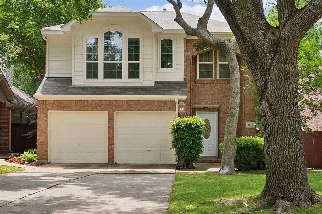 4816 Rockcreek Lane, Plano, TX 75024 Brick and siding exterior with a two-car garage