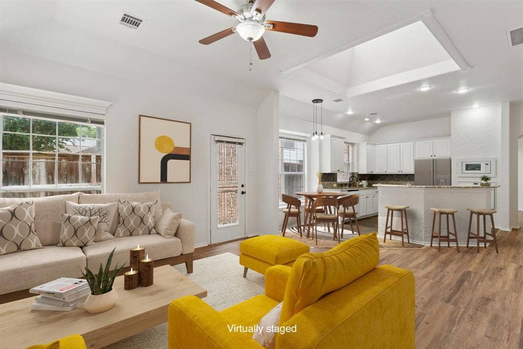 4816 Rockcreek Lane, Plano, TX 75024 Wood-finish flooring throughout, vaulted ceiling, and a ceiling fan
