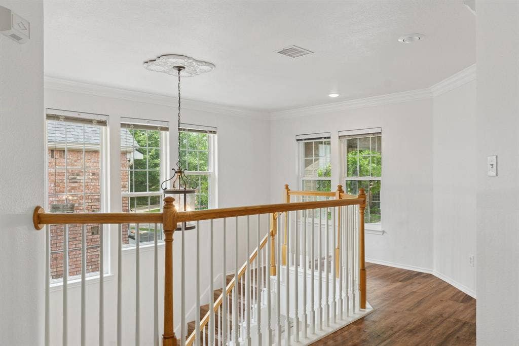 4816 Rockcreek Lane, Plano, TX 75024 Staircase with wood-finish handrails, white balusters, and recessed lighting