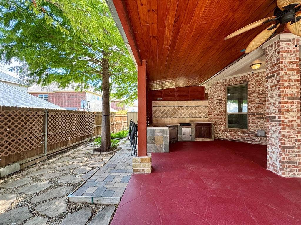 8730 Isaac Street, Plano, TX 75024 Fenced backyard featuring an outdoor kitchen, a ceiling fan, and a patio area