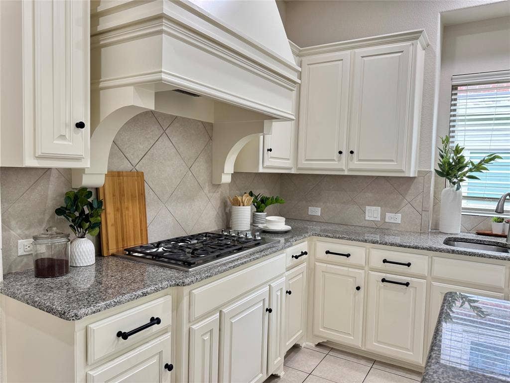8730 Isaac Street, Plano, TX 75024 Kitchen with stainless steel gas cooktop, custom range hood, tasteful backsplash, and light tile patterned floors