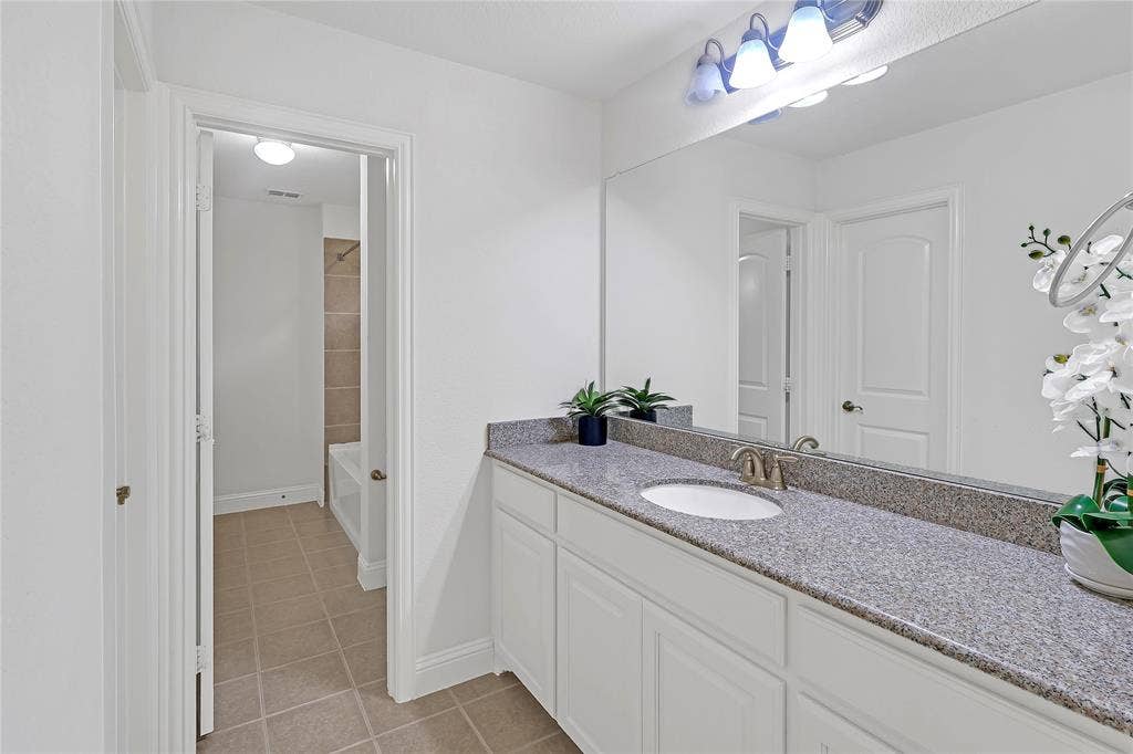 8730 Isaac Street, Plano, TX 75024 Full bath with tile patterned floors and vanity