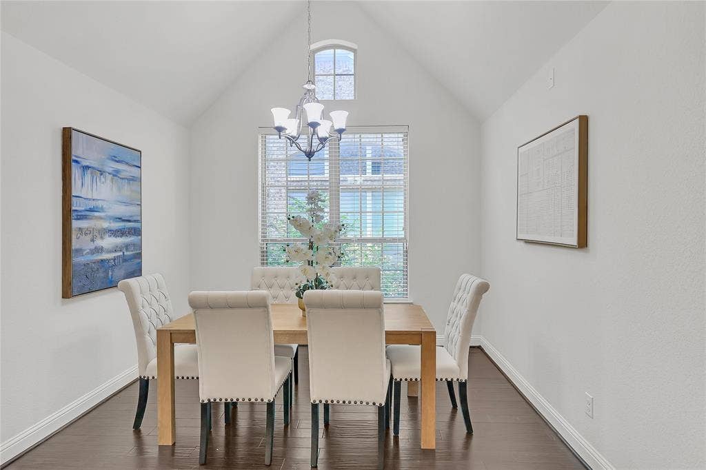8730 Isaac Street, Plano, TX 75024 Dining room with a chandelier, dark wood finished floors, and lofted ceiling
