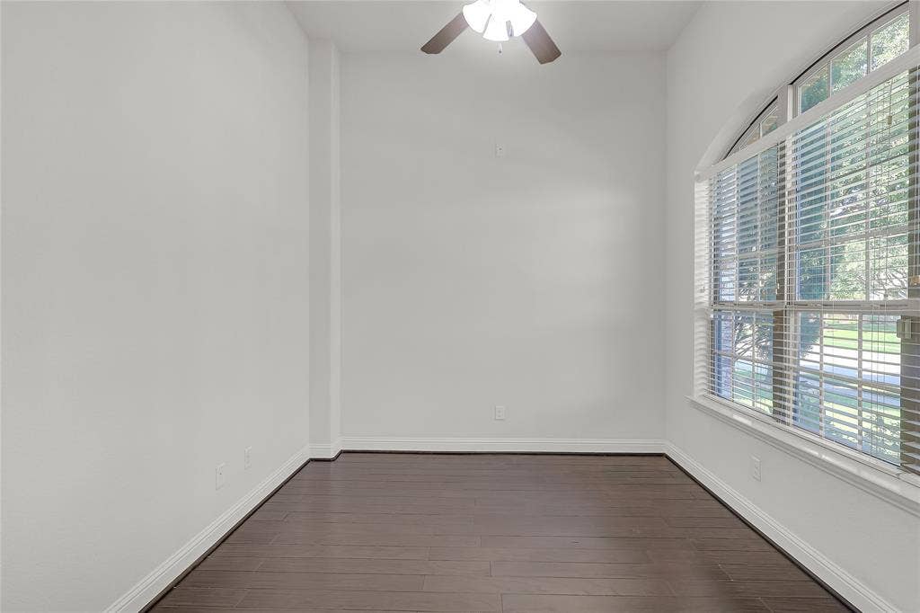 8730 Isaac Street, Plano, TX 75024 Empty room with dark wood-style floors and a ceiling fan