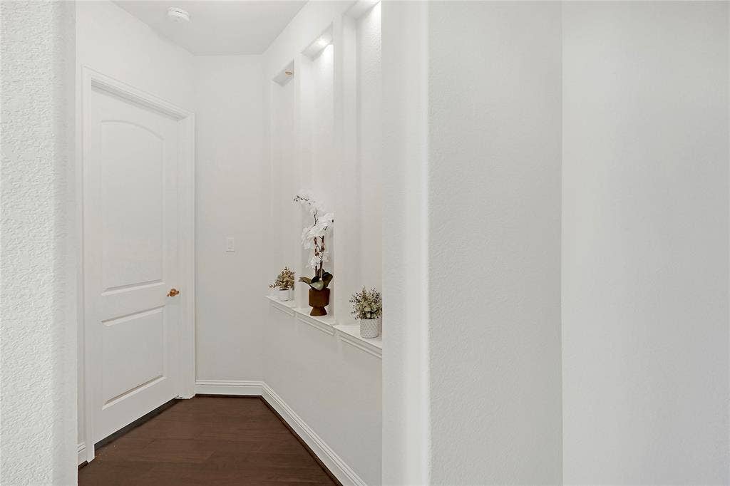 8730 Isaac Street, Plano, TX 75024 Hall with dark wood-style flooring and baseboards