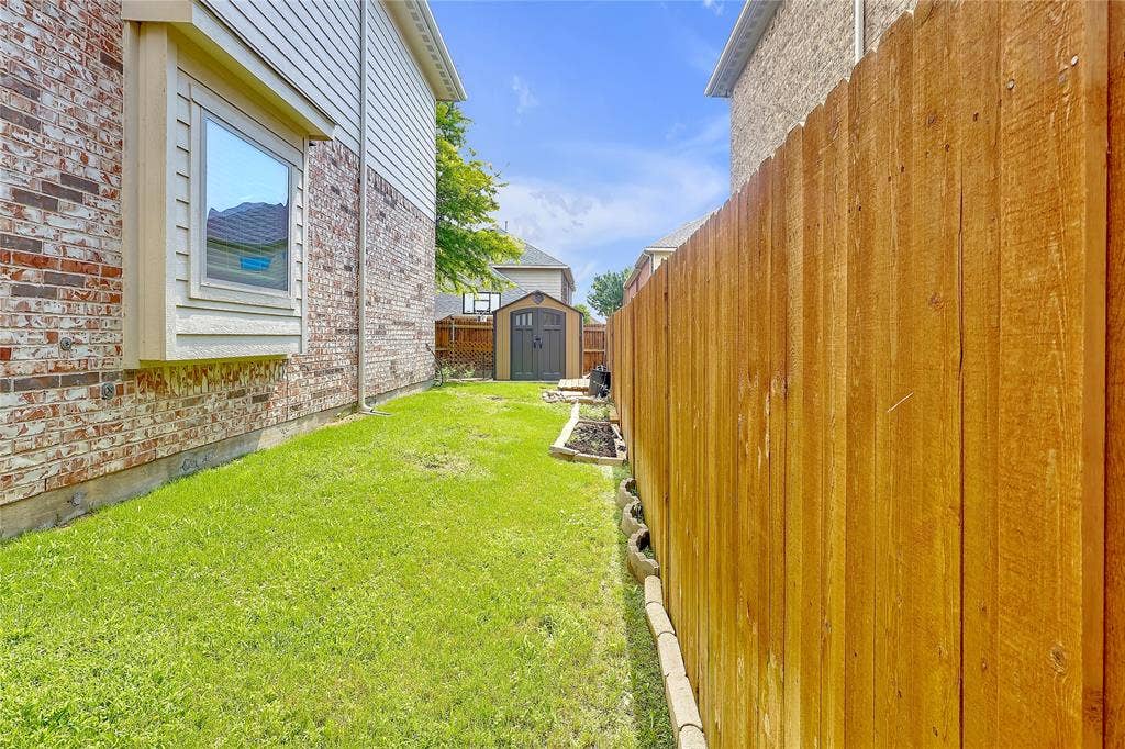8730 Isaac Street, Plano, TX 75024 View of yard with a storage unit