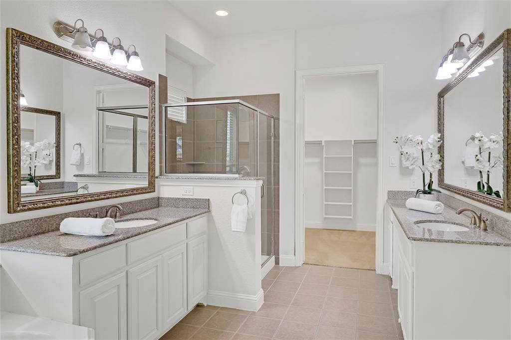 8730 Isaac Street, Plano, TX 75024 Bathroom with a stall shower, a spacious closet, double vanity, tile patterned floors, and recessed lighting