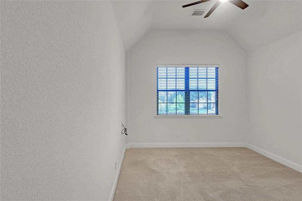 8730 Isaac Street, Plano, TX 75024 Spare room with a ceiling fan, light colored carpet, and lofted ceiling
