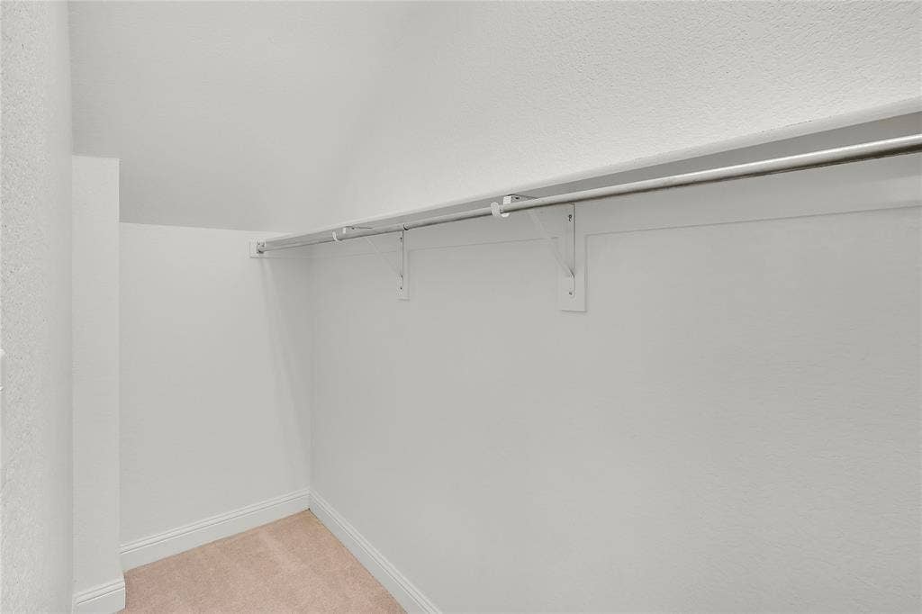 8730 Isaac Street, Plano, TX 75024 Walk in closet featuring light colored carpet